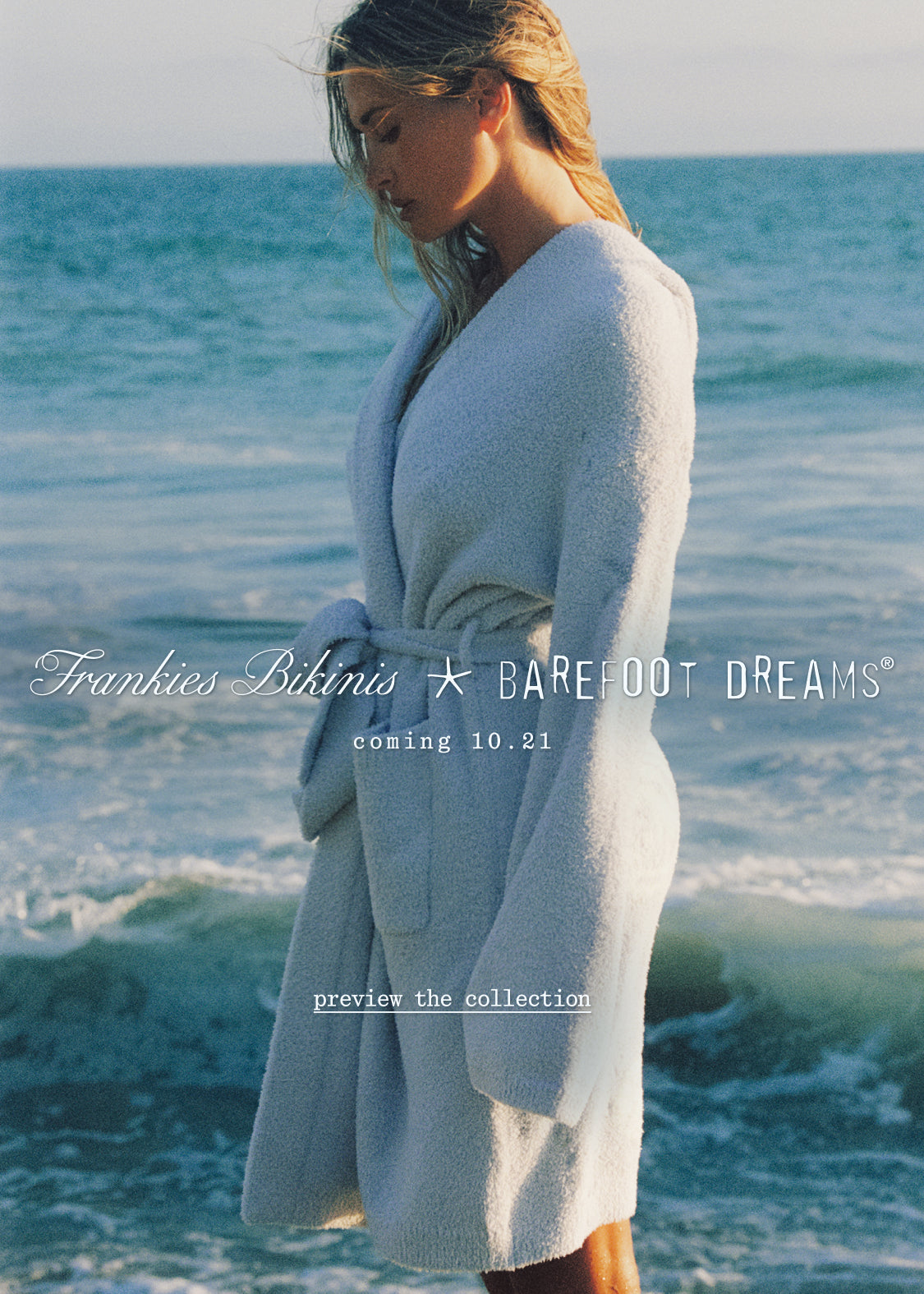 Francesca standing on a beach wearing a plush blue robe, with ocean waves behind her. Text overlays read 'Frankies Bikinis', 'BAREFOOT DREAMS', and 'coming 10.21'