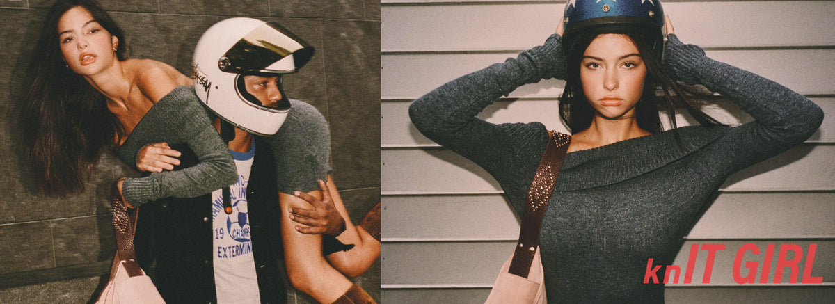 A split-screen fashion photo featuring a woman modeling a dark gray off-the-shoulder knit sweater. On the left, she is posed with a man wearing a white motorcycle helmet, and on the right, she is posing against a white paneled wall wearing a blue helmet.