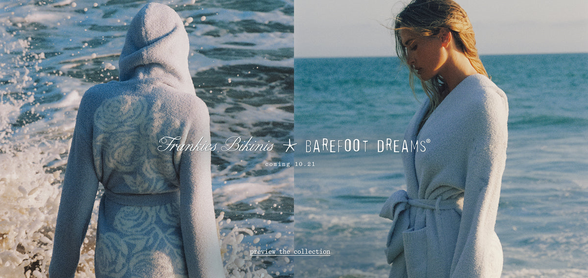 A split-screen lifestyle image showing a francesca wearing a light blue hooded robe at the beach, with ocean waves in the background. The left side shows her from behind, revealing a subtle floral pattern on the back, and the right side shows her from the front in a soft wrap robe.